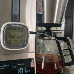 A digital thermometer is attached to the coffeemaker. It shows a temperature of 200 degrees.