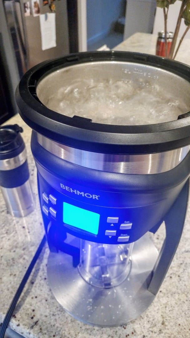 The Behmor Brazen Plus running its calibration program. The lid is off, exposing a reservoir full of boiling water.