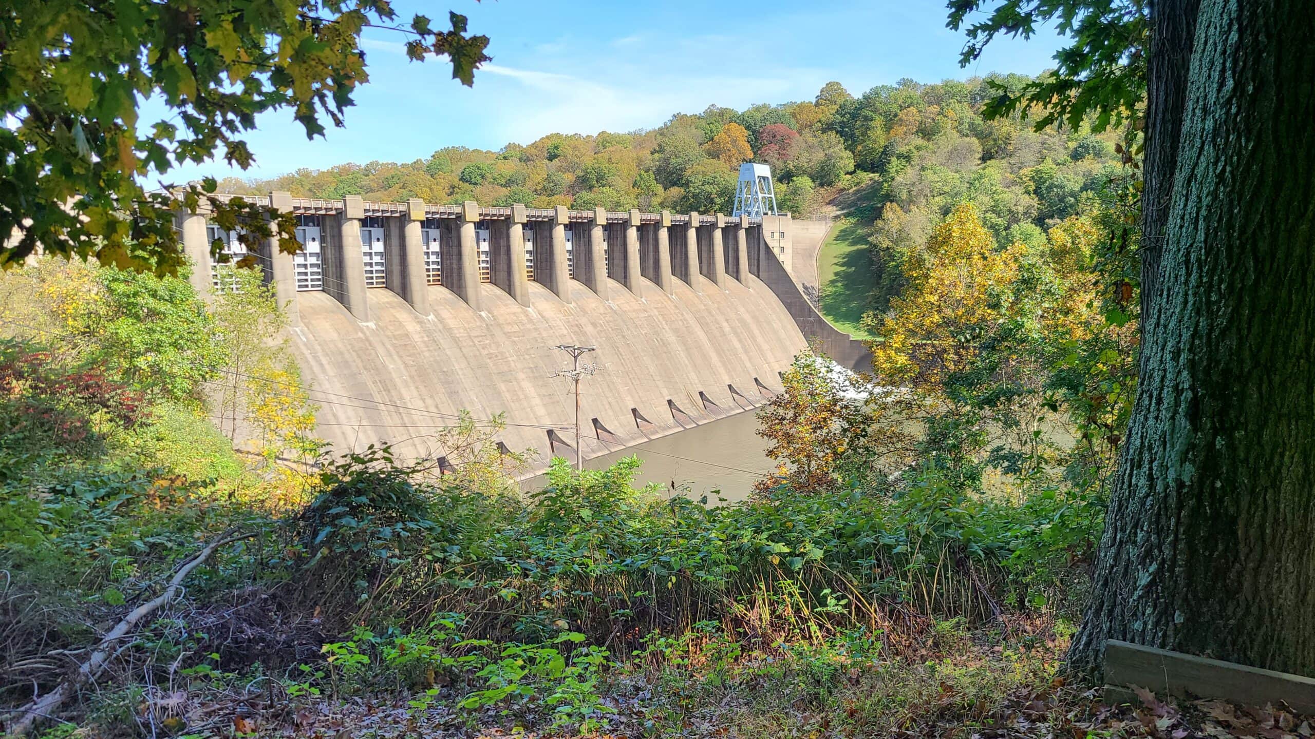 A large concrete dam spans the Conemaugh River.